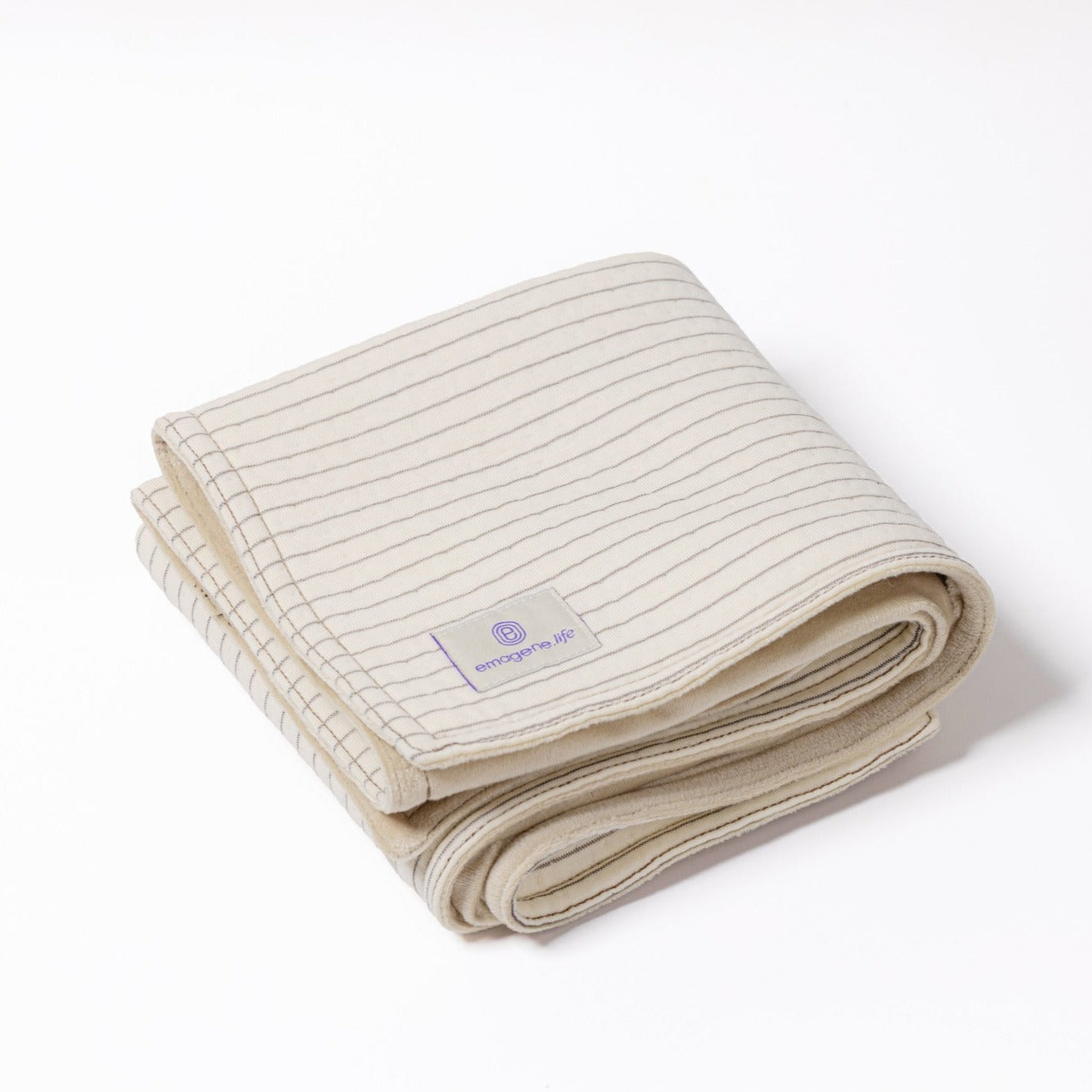 Folded Emagene organic cotton earthing mat with silver fibre grid for optimal conductivity.