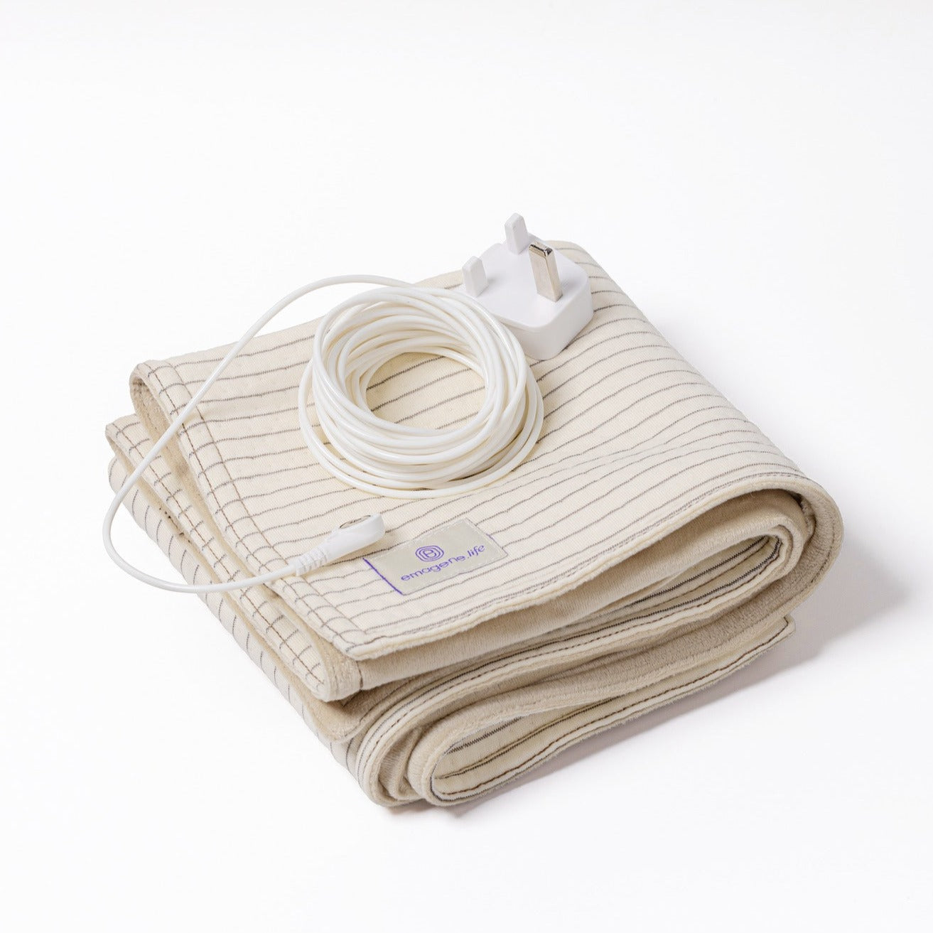 Emagene Earthing Mat crafted with silver fibre and organic cotton, folded with white cable and plug on top.